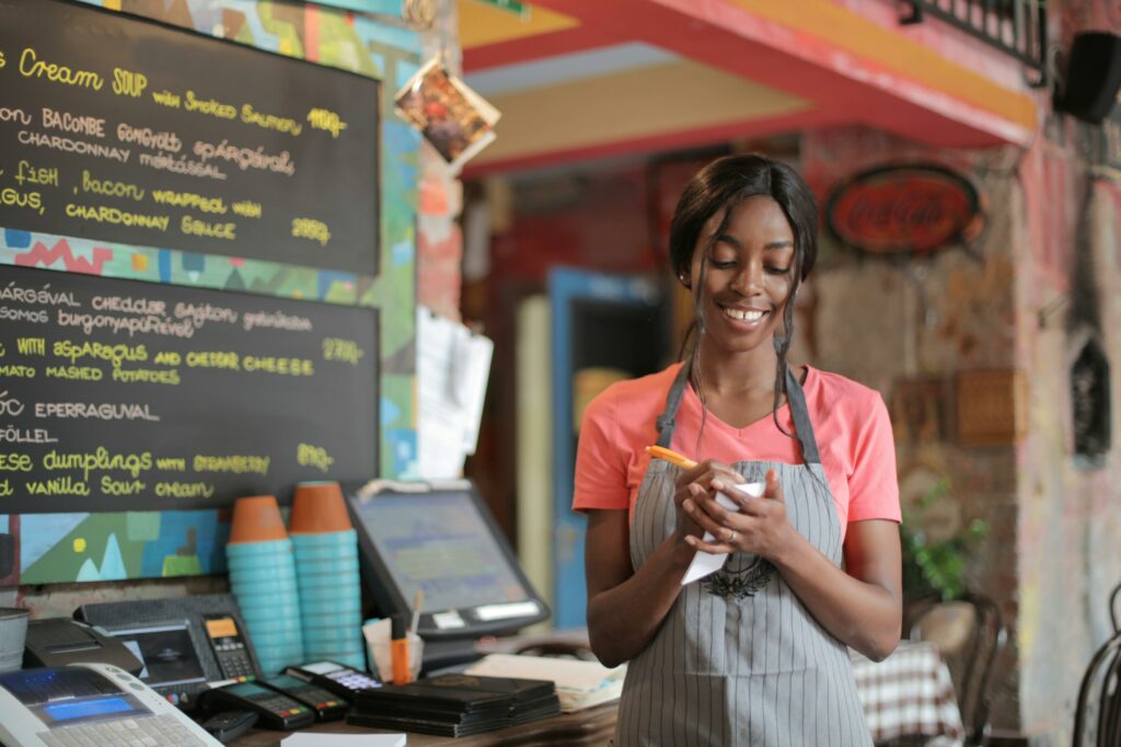 a woman in a apron writing on a paper