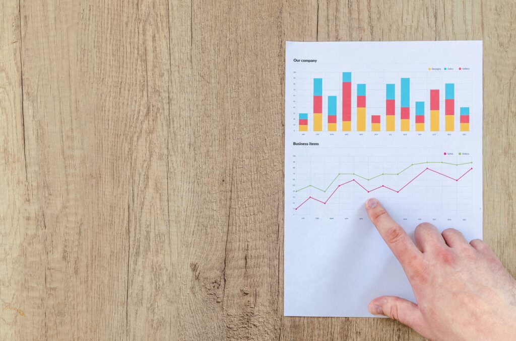 a hand pointing at a graph