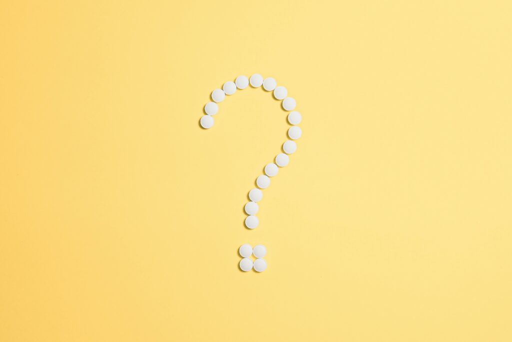 a question mark made of pills