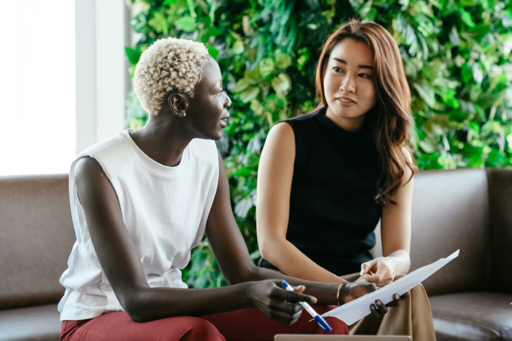 a woman sitting next to another woman