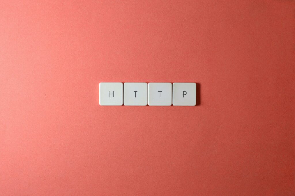 a group of white tiles with black letters http on a pink background