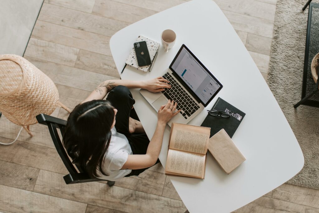 a woman sitting at a table using a laptop