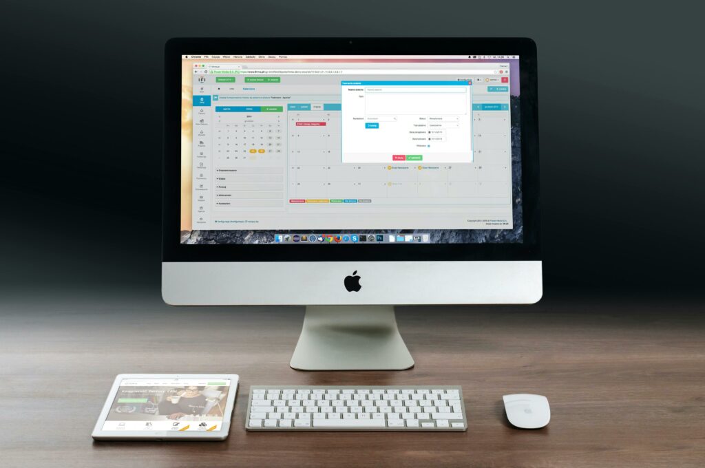 a computer and a phone on a desk