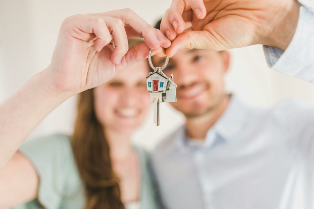 a man and woman holding a key