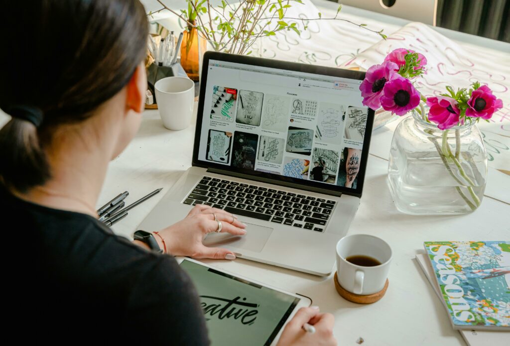 a woman sitting at a desk using a laptop