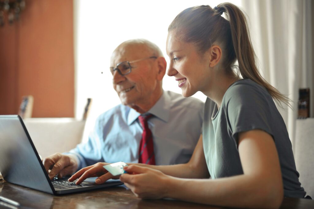 a man and woman looking at a laptop