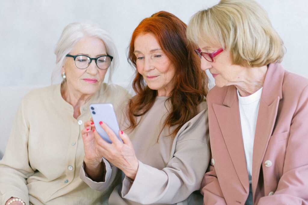 a group of women looking at a phone