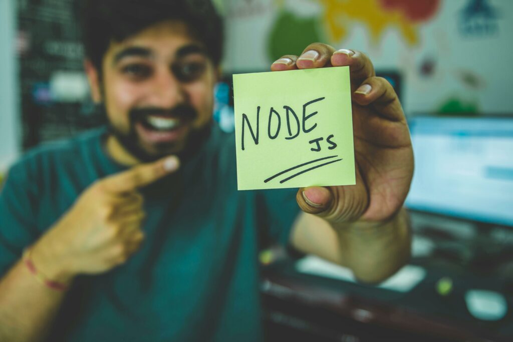 a man pointing at a yellow note