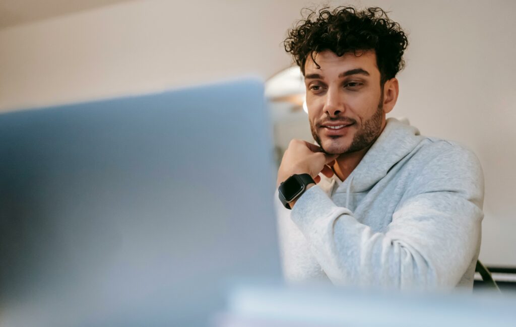 a man looking at a laptop