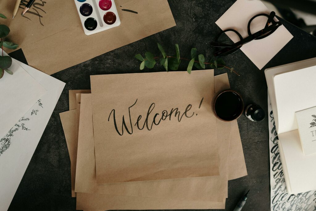 a brown paper with a black text on it next to a cup of coffee and glasses