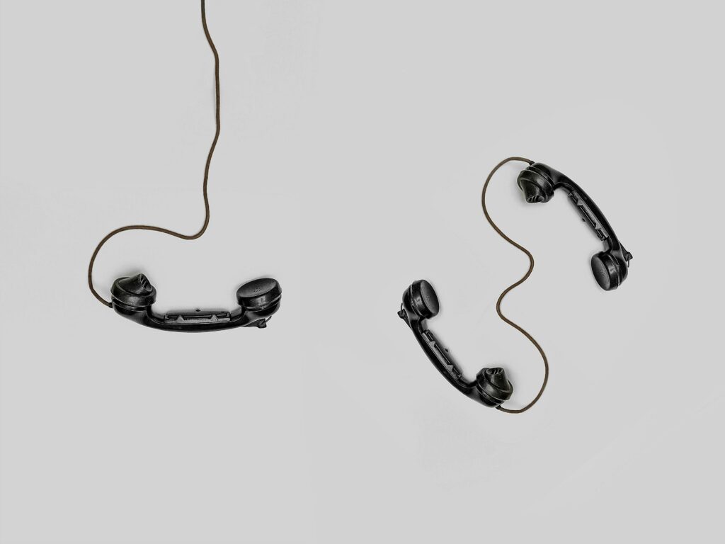 a pair of handsets with cord