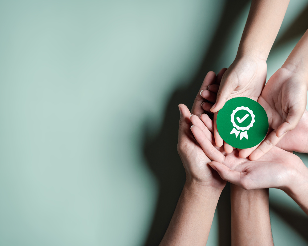 a group of hands holding a green circle with a check mark