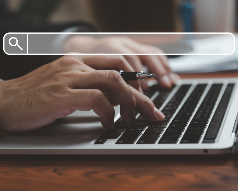 a person's hands on a laptop keyboard