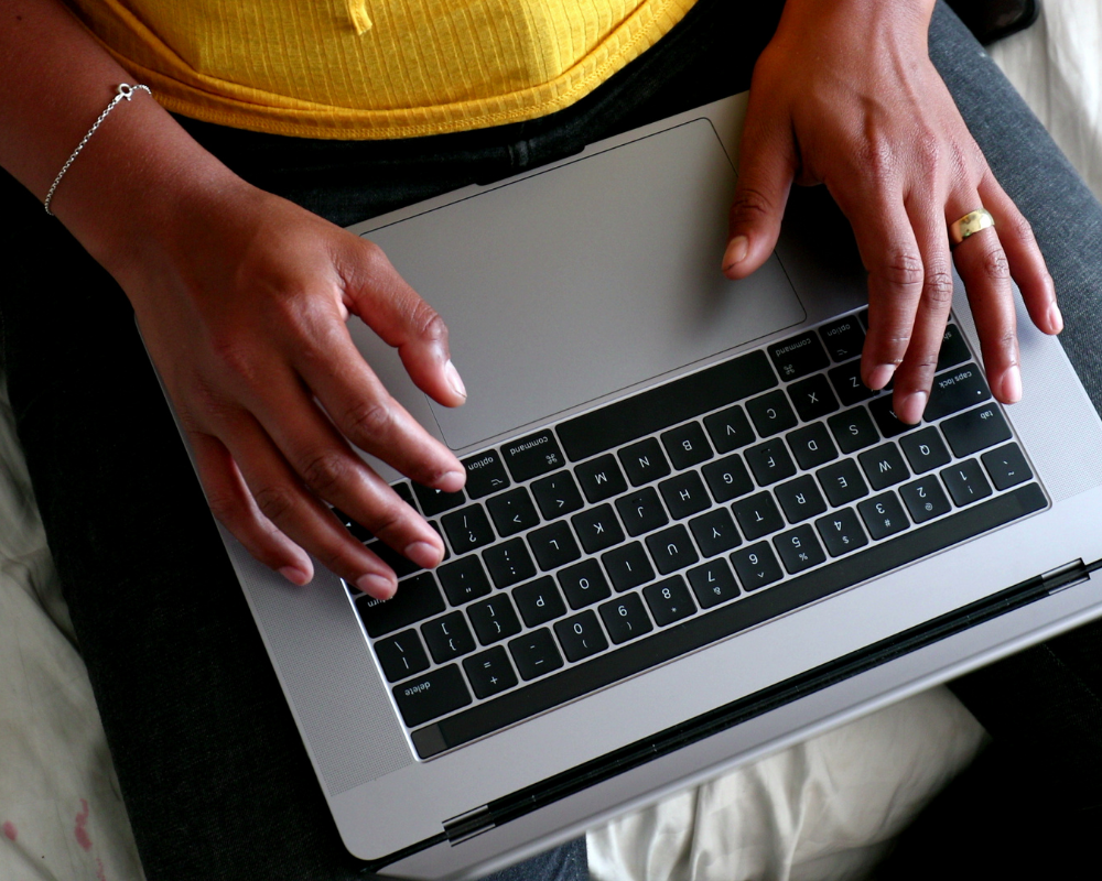 a person sitting on a laptop