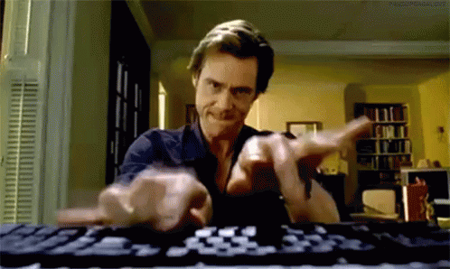 a man pointing at a keyboard