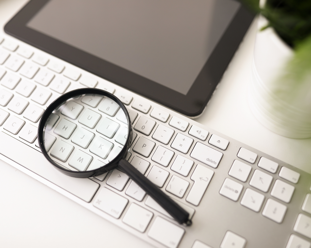 a magnifying glass on a keyboard
