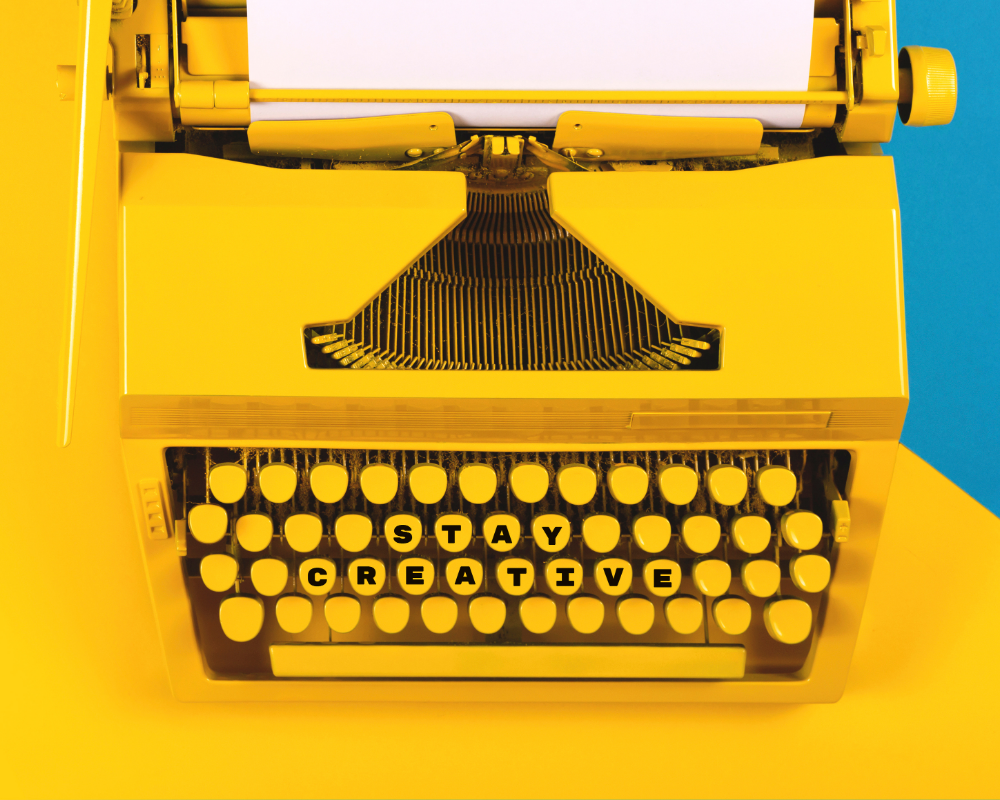 a yellow typewriter with a paper and a note