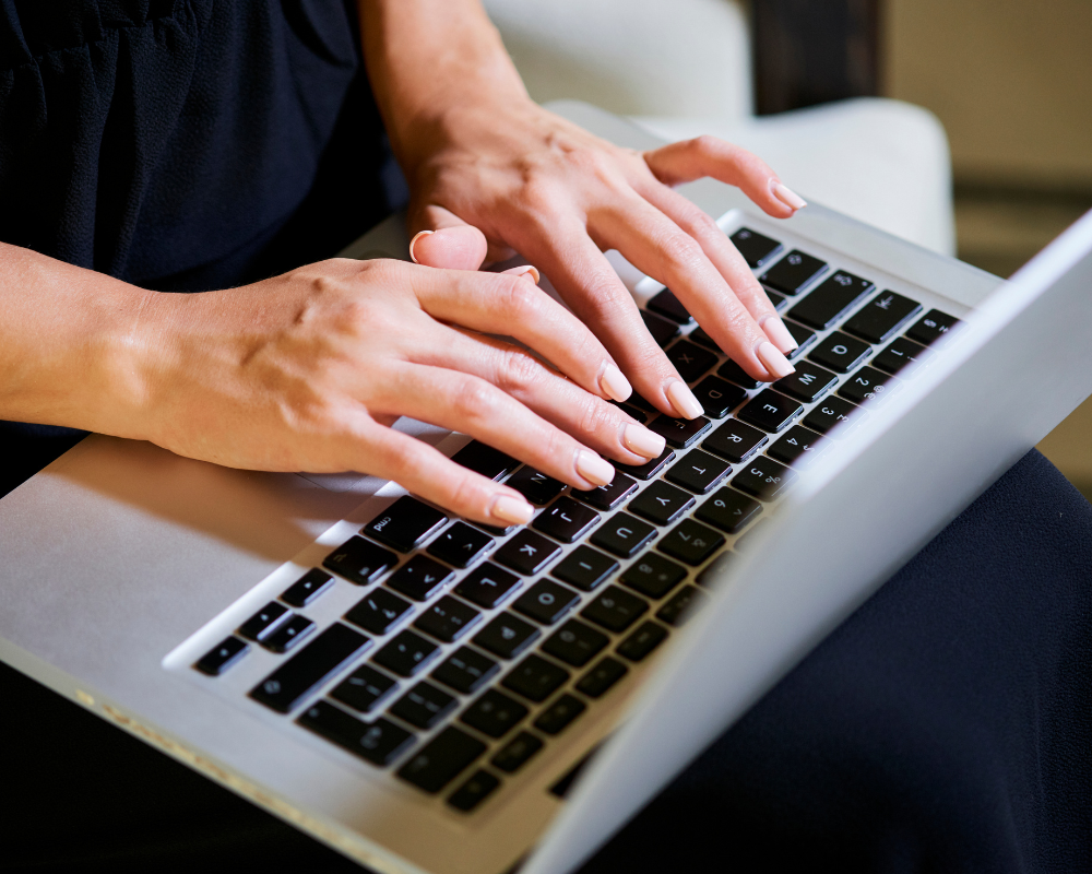 a person typing on a laptop