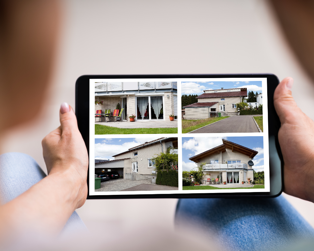 a person holding a tablet with a picture of a house