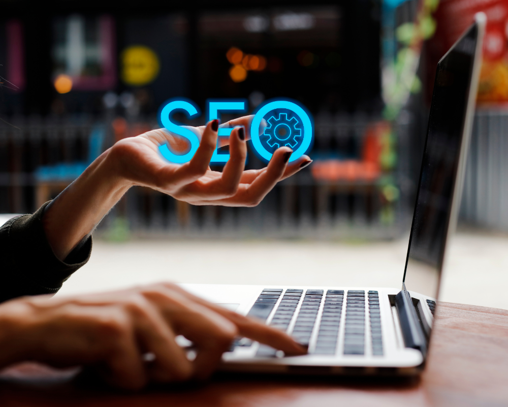 a person's hand holding a laptop