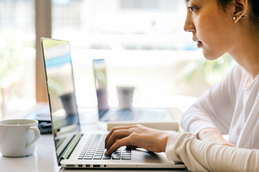 a woman typing on a laptop