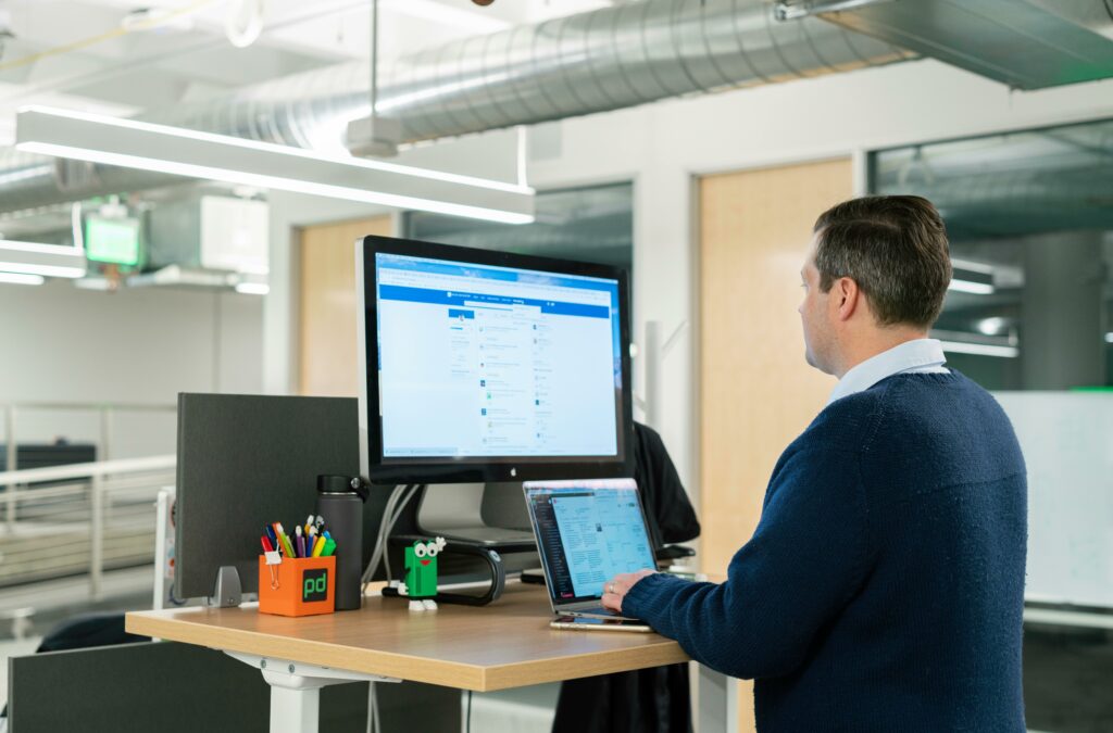 a man using a laptop at a desk