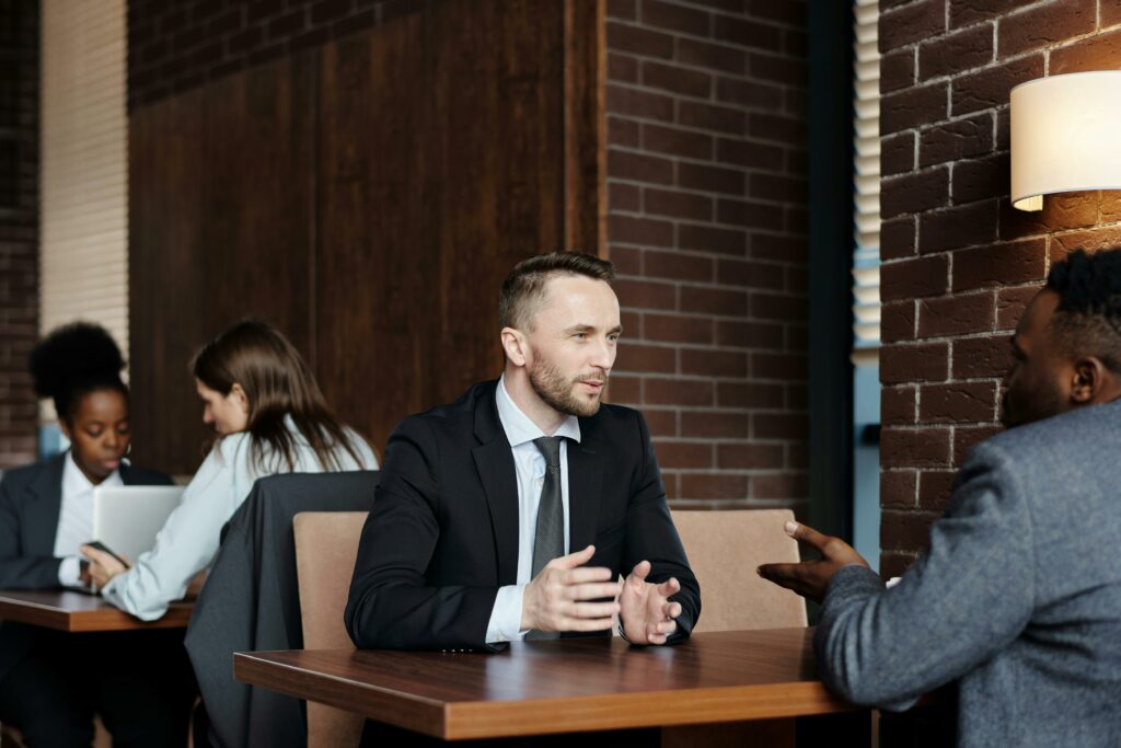 a man in a suit talking to a woman